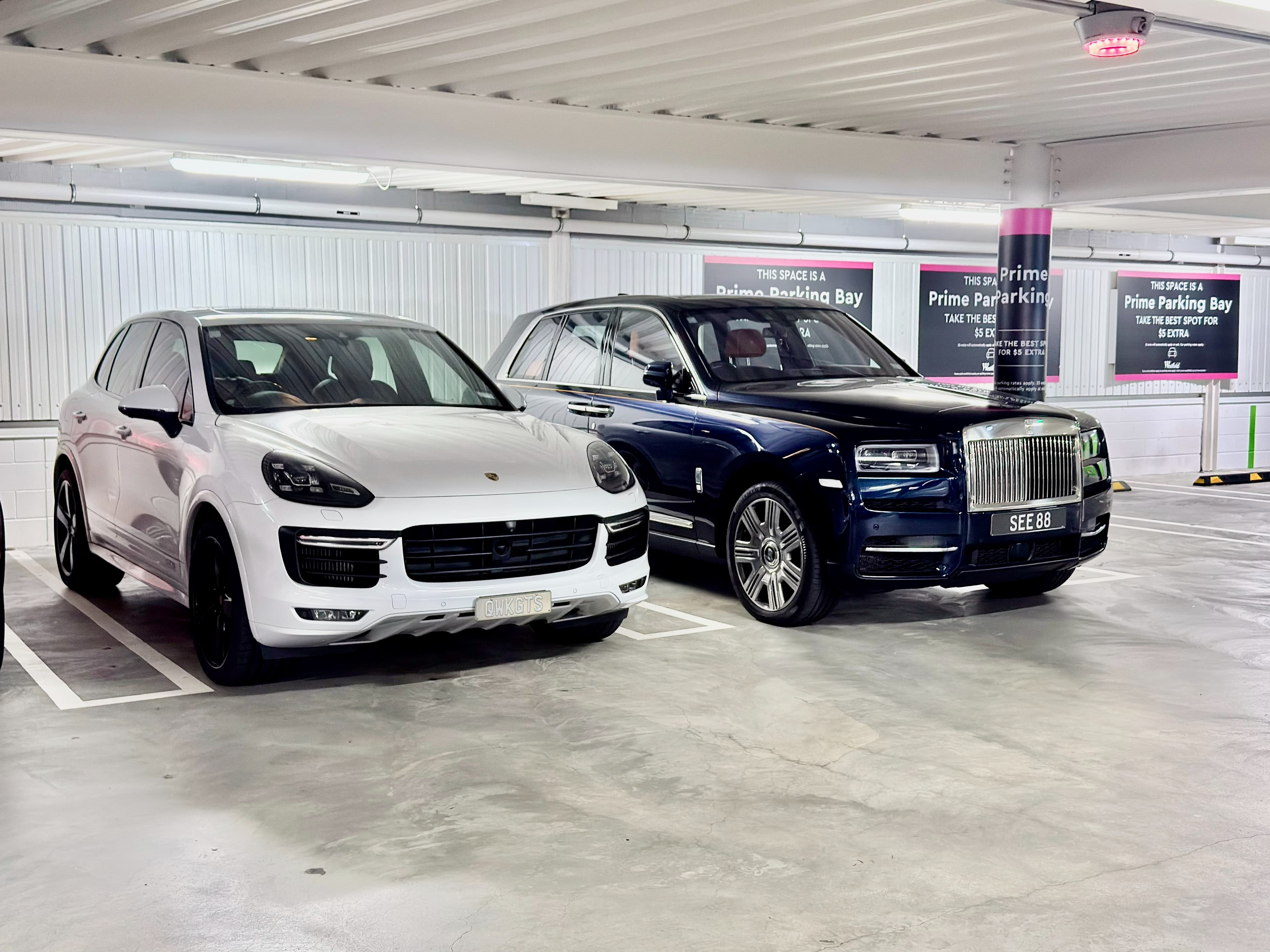 Prestige Automotive vehicles including a white Porsche and a Rolls-Royce